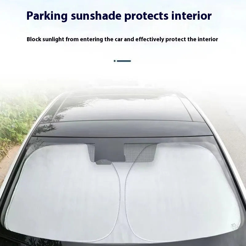 Titanium silver aluminium foil car windscreen sunshade unfolded on a dashboard.