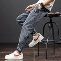 Men's loose straight-leg cargo casual jeans in blue, showing cargo pockets and mid-waist fit.