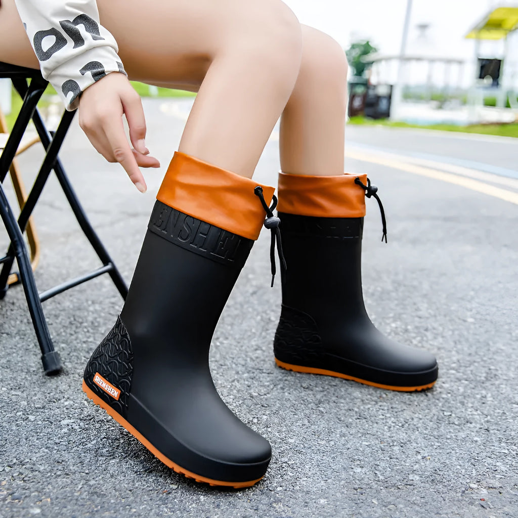 Women's solid colour PVC rain boots with non-slip soles in apricot, black, brown, or pink waterproof mouth options