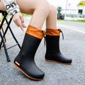 Women's solid colour PVC rain boots with non-slip soles in apricot, black, brown, or pink waterproof mouth options