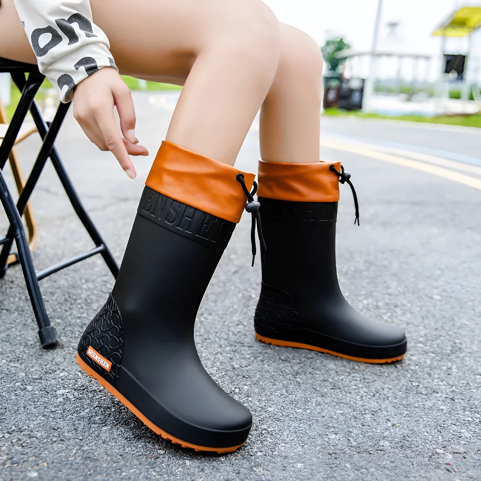 Women's solid colour PVC rain boots with non-slip soles in apricot, black, brown, or pink waterproof mouth options