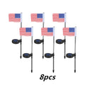 Solar-powered stainless steel garden flag light showing American flag design with white LEDs illuminated.