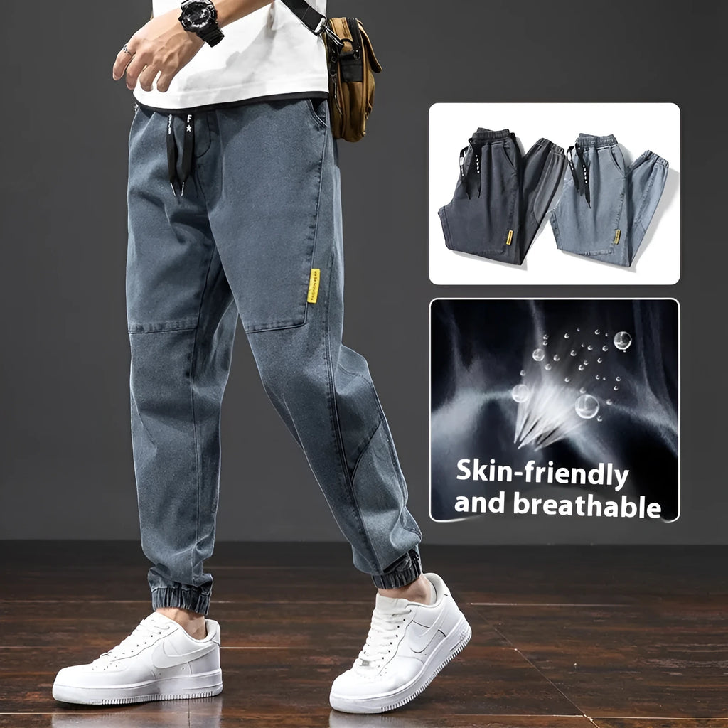 Men's loose straight-leg cargo casual jeans in blue, showing cargo pockets and mid-waist fit.
