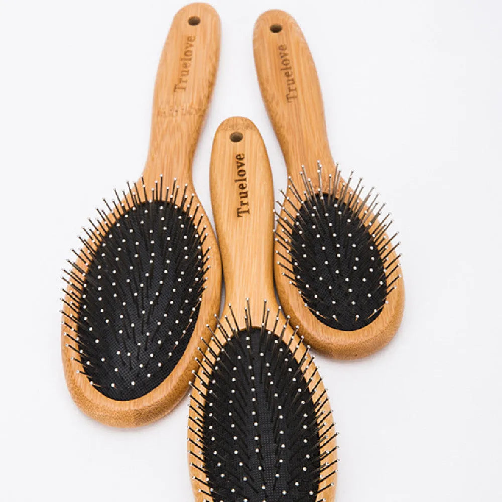 Medium pet deshedding comb with bamboo handle and stainless steel needles in original bamboo colour on a flat surface
