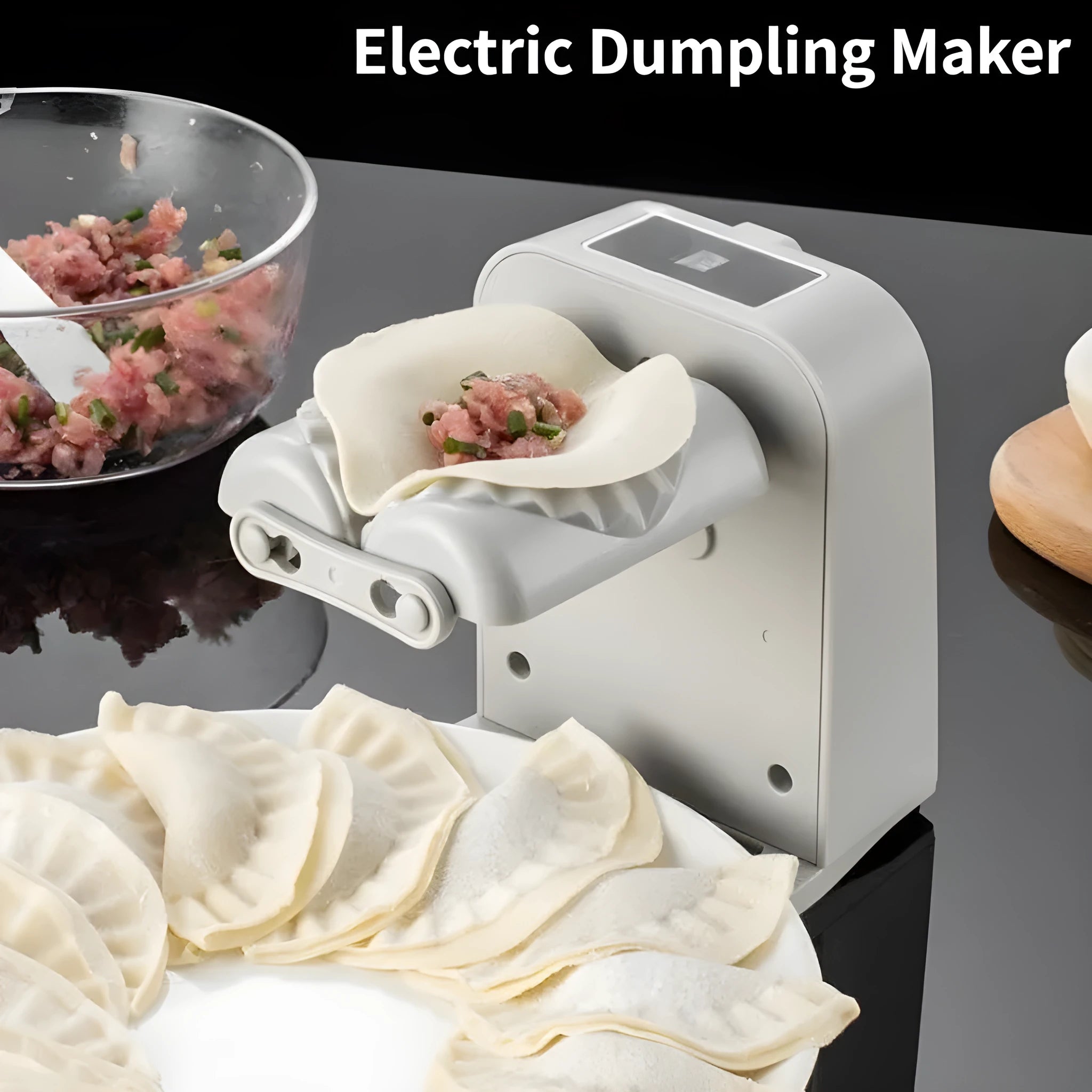 White automatic electric dumpling maker machine with charging cable, brush, and spoon.