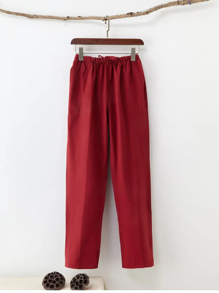 Man wearing beige pure cotton casual trousers with a drawstring waist and belt.