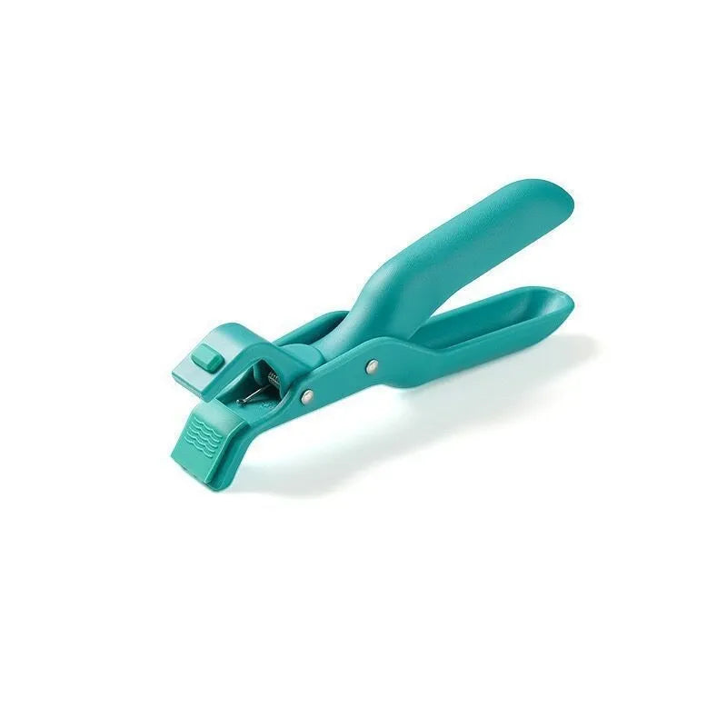 Carmine coloured anti-scalding clip with PP handle and silicone grip on kitchen counter