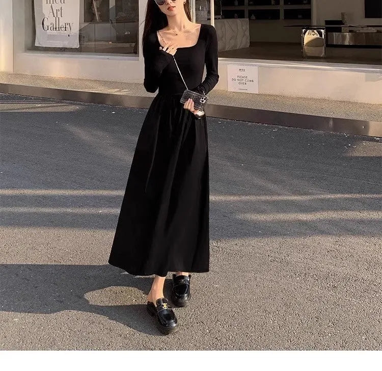 Black square collar knitted A-line dress with elastic waist and long sleeves on a model