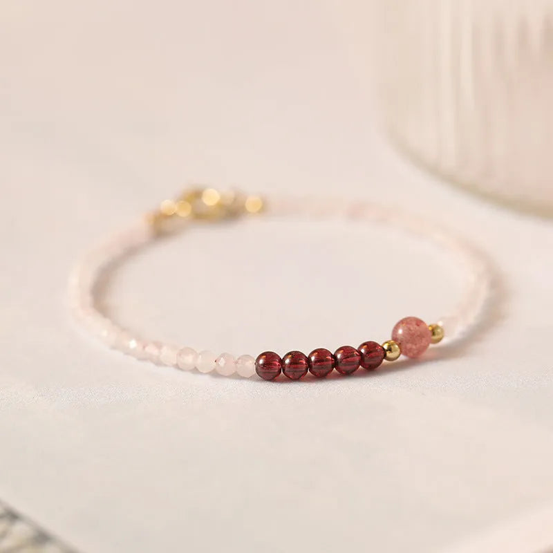 Handmade pink crystal bracelet with strawberry quartz beads and a zodiac animal charm