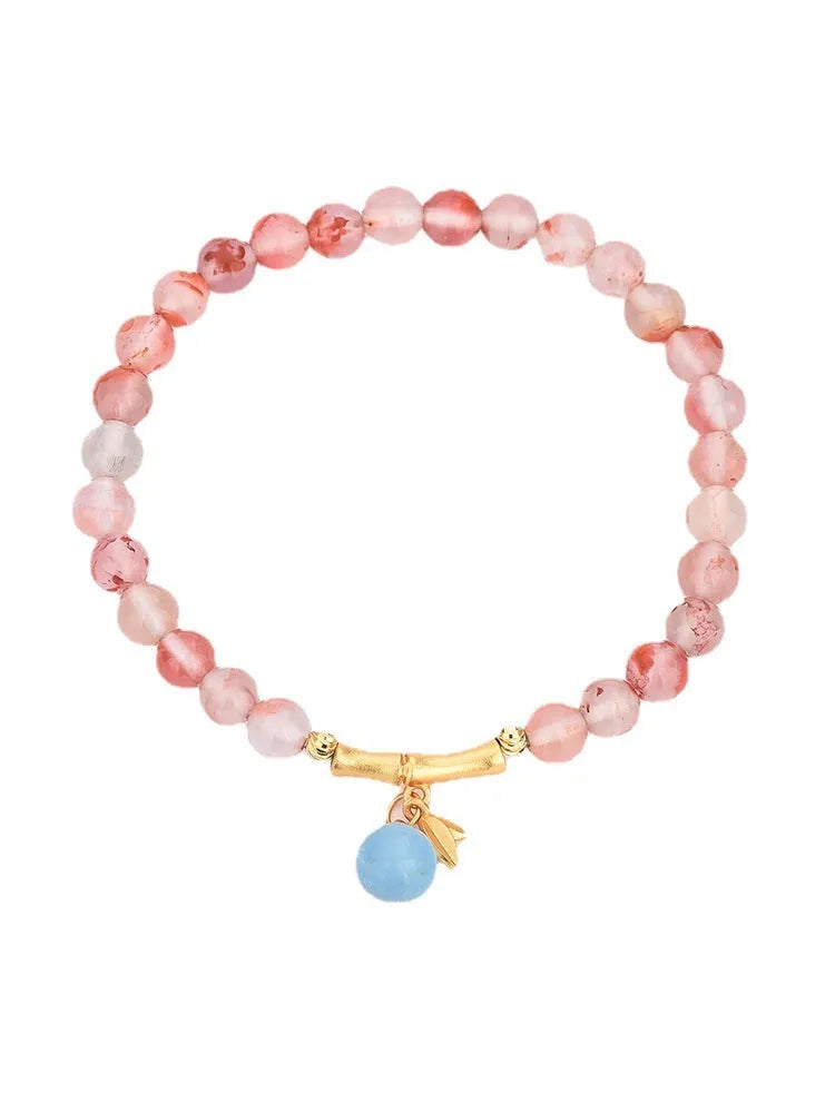 Nanhong agate bracelet with flower design and bamboo joint elements on wrist