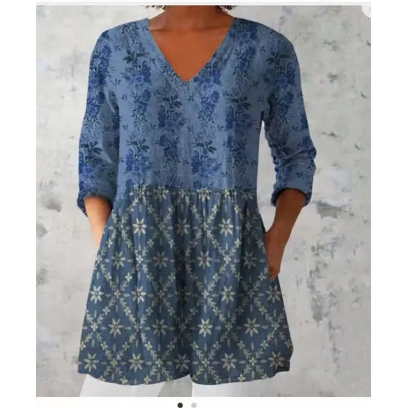 Women's floral wave print dress with wide waist and three-quarter length sleeves on a hanger.