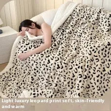 Double-layer taffeta blanket with woven leopard print pattern draped over sofa