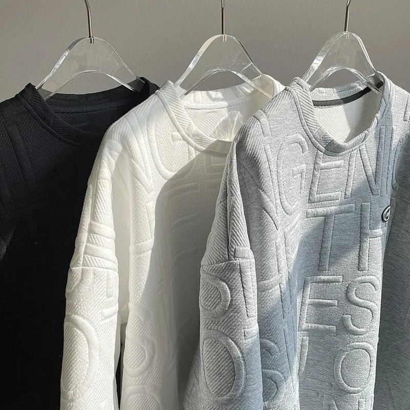Men's grey loose-fit short sleeve t-shirt featuring a raised three-dimensional letter design on the front.