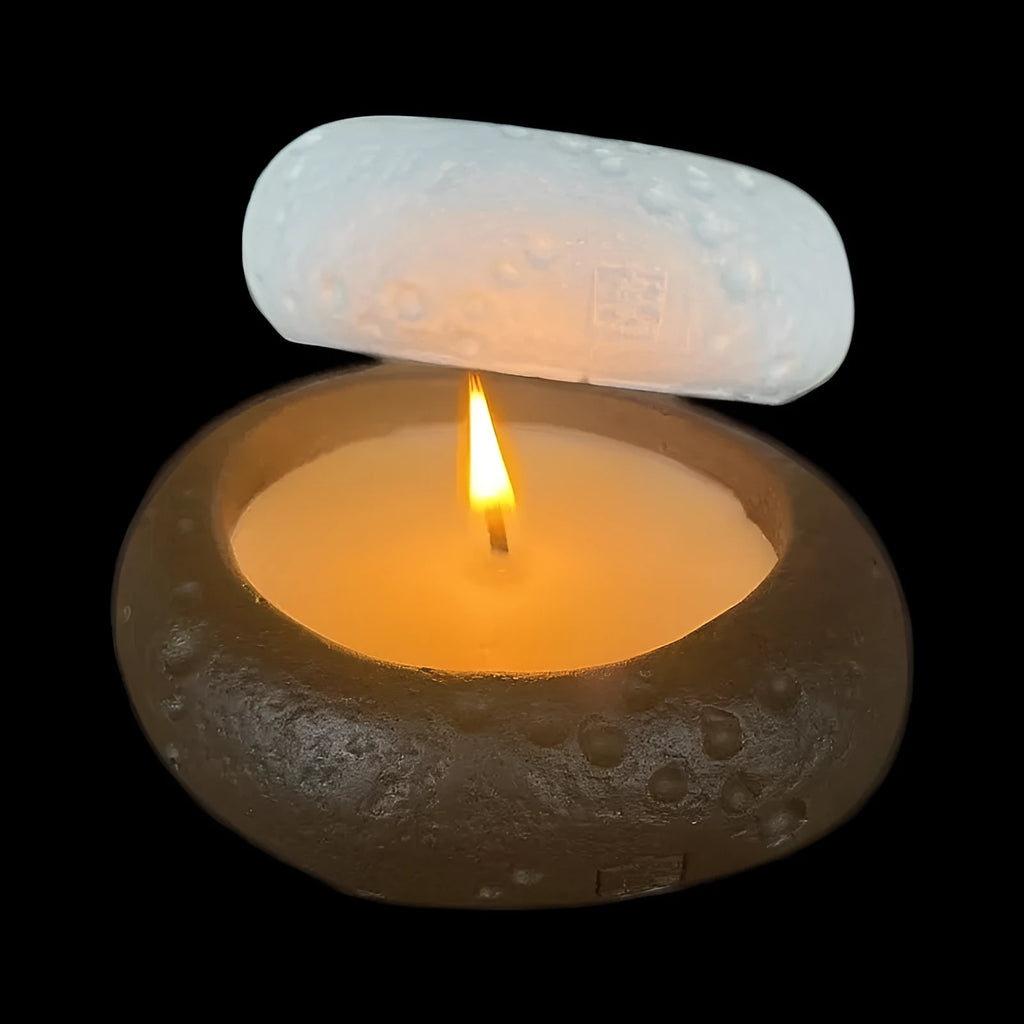 White concrete candle holder on a flat surface with a tea light inside