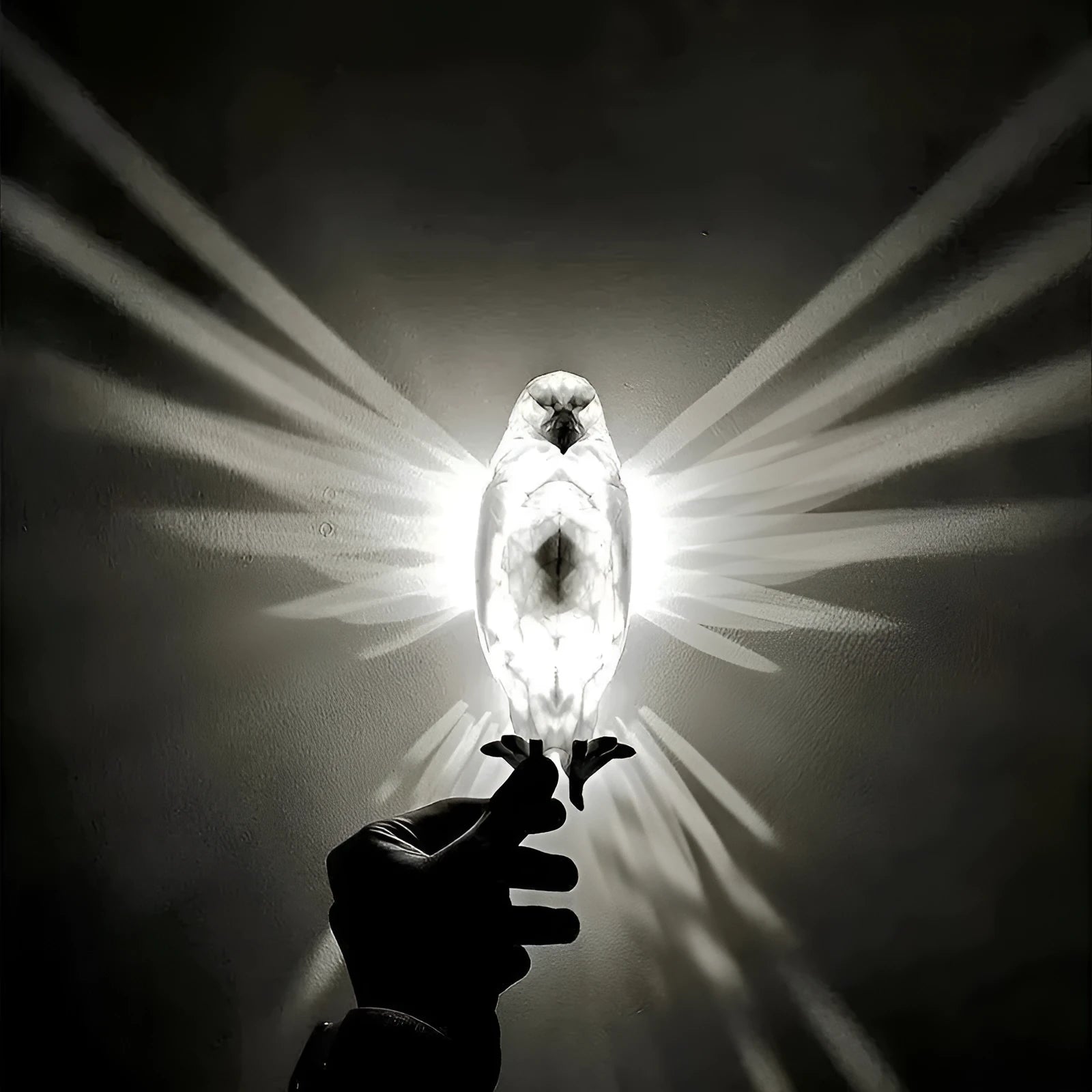 Eagle-shaped 3D printed resin wall lamp projecting a silhouette shadow on a wall.