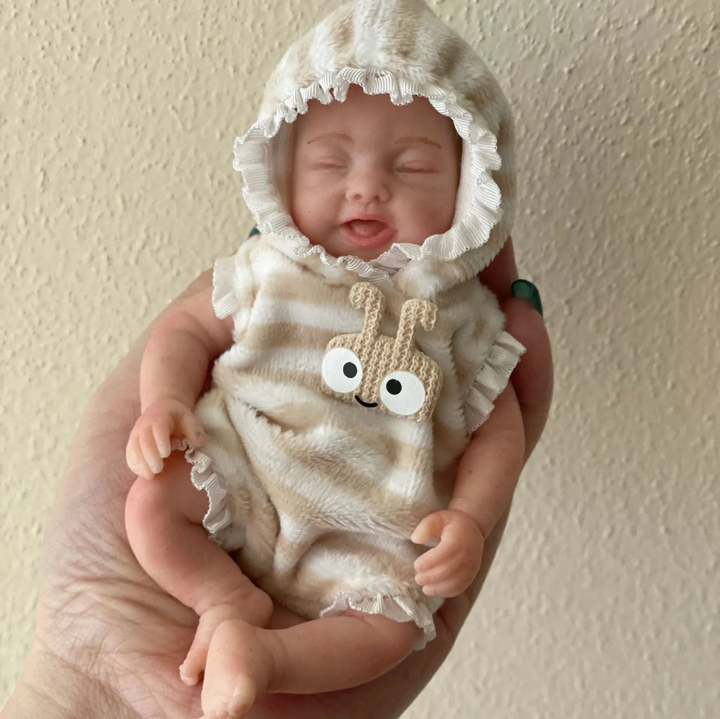 15cm solid silicone MINI palm doll simulation baby, bald girl version, on display