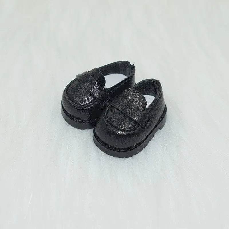 A pair of 17cm scale PU doll shoes in a selected colour and style, such as black leather shoes or brown boots.