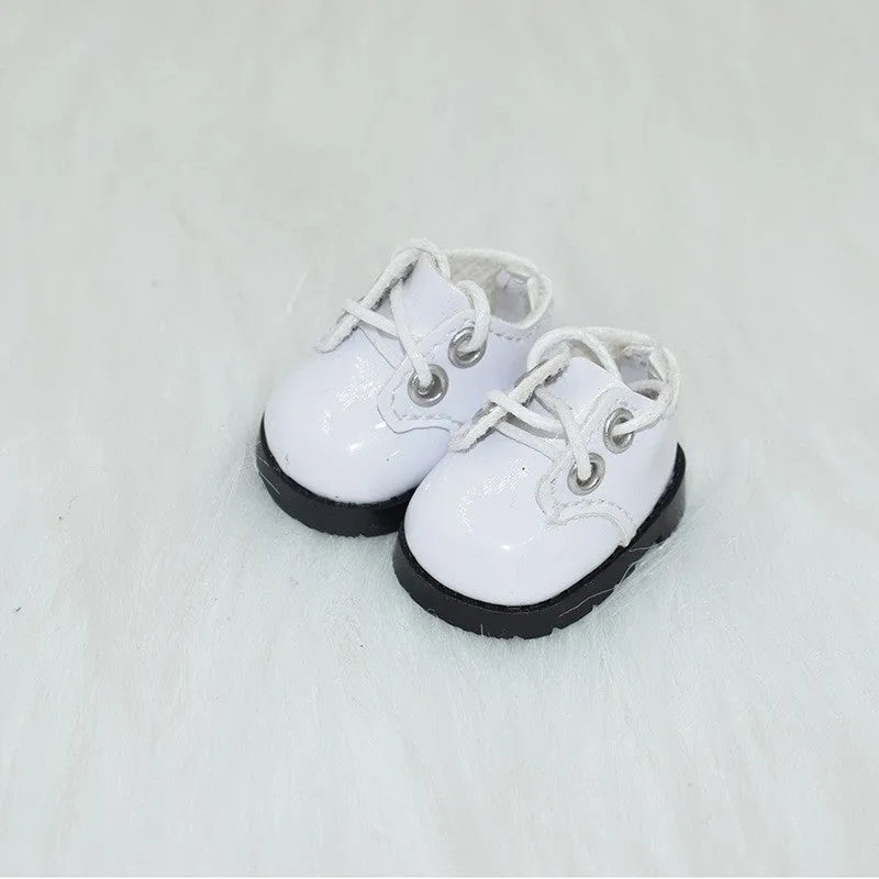 A pair of 17cm scale PU doll shoes in a selected colour and style, such as black leather shoes or brown boots.