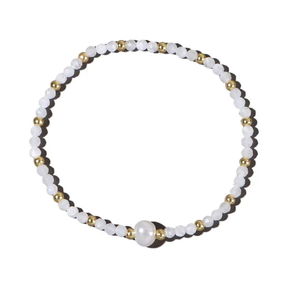 Close-up of a unisex natural stone bracelet with geometric ellipse beads on a wrist.
