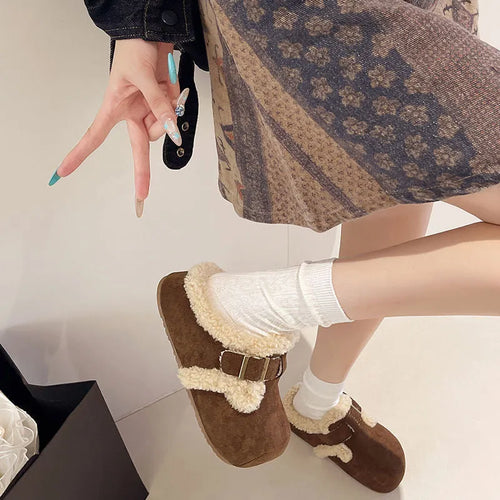 Baotou semi-drag fleece slippers in brown and camel with faux fur lining, closed toe, and rubber sole on a wooden floor