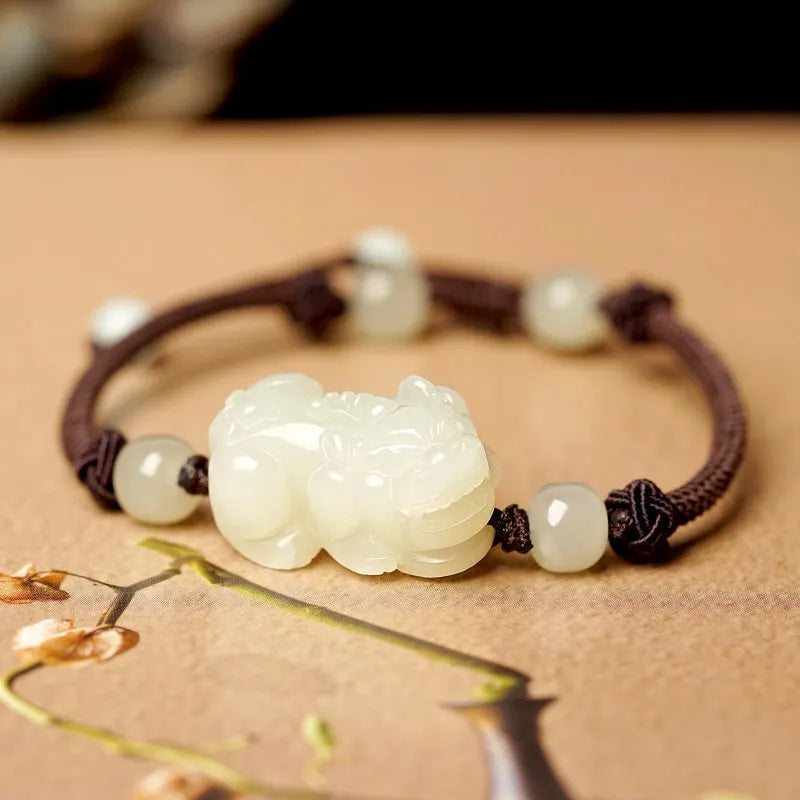 Traditional Chinese Hetian jade bracelet with black and red braided ropes and jade beads on elastic cord