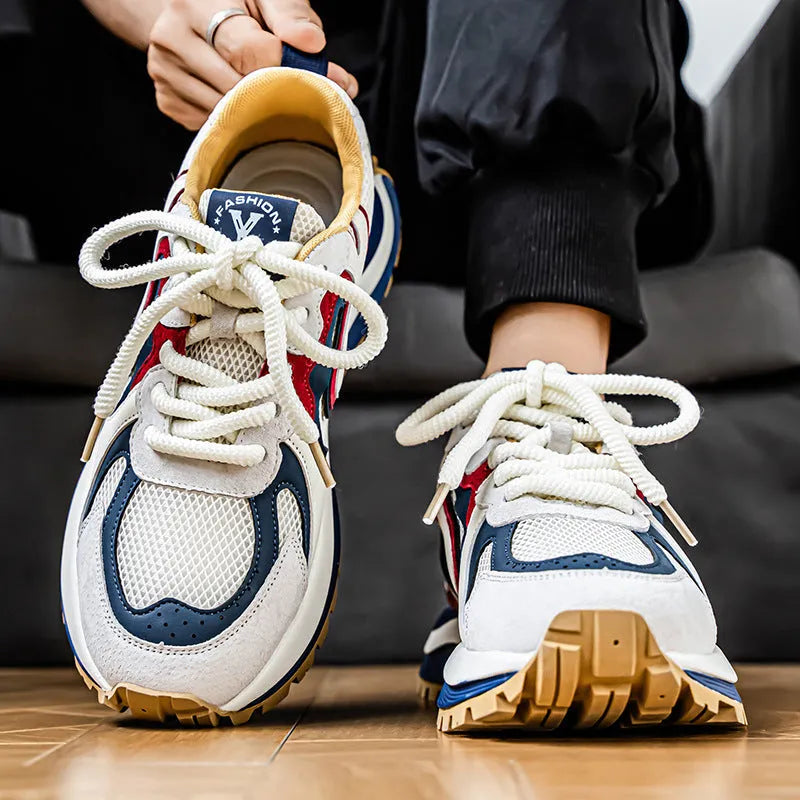 Men's yellow synthetic leather and mesh casual sneaker with rubber sole and lace-up front.