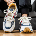 Men's yellow synthetic leather and mesh casual sneaker with rubber sole and lace-up front.
