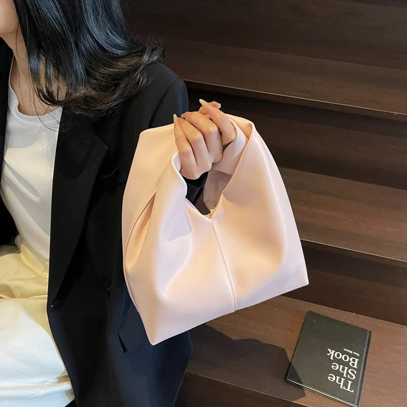 Casual dumpling-shaped women's PU shoulder bag in multiple colours showing internal phone and file pockets.