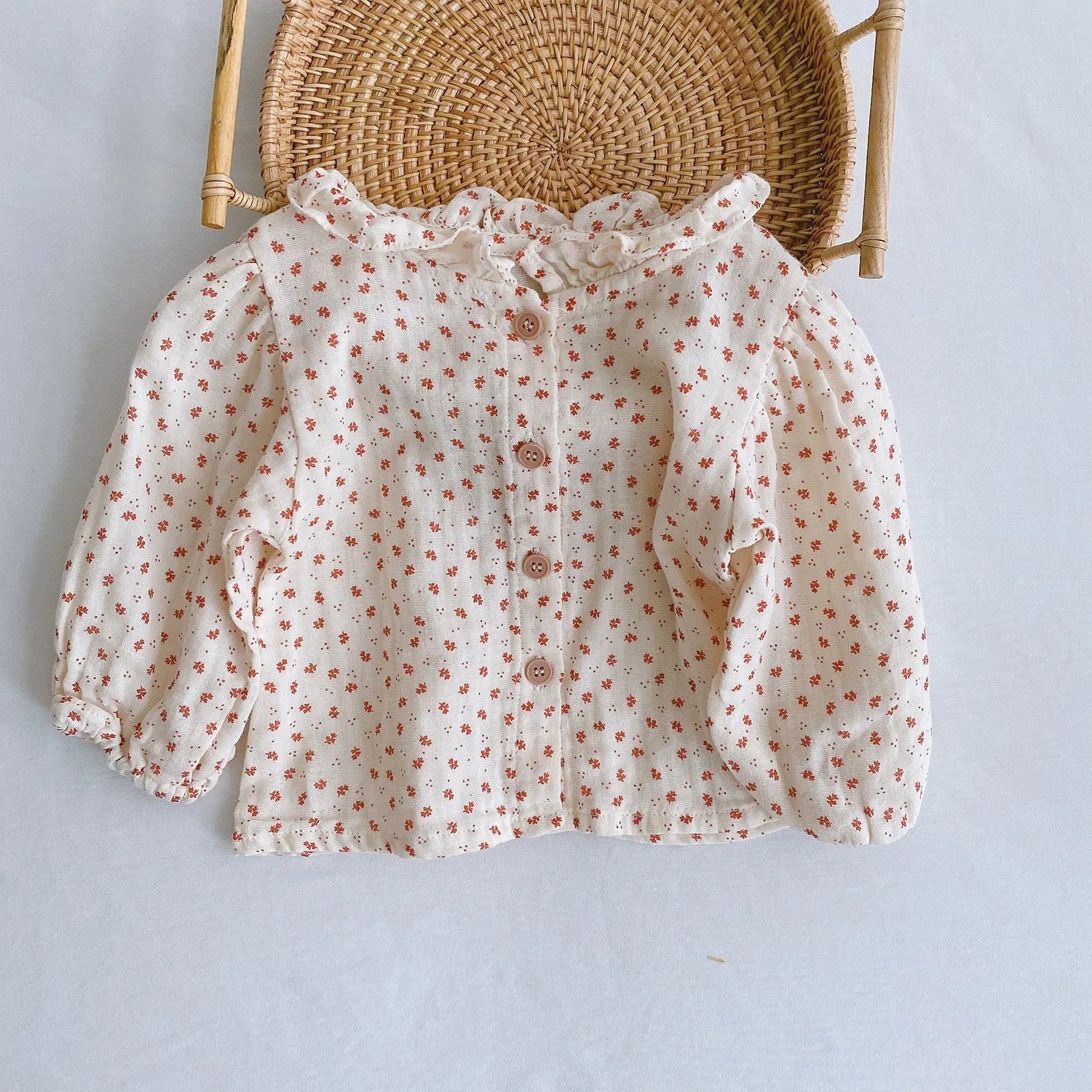 Baby girl romper with pleated lotus leaf design in cotton fabric, showing triangle climb style
