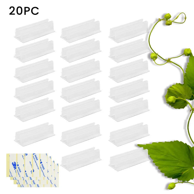 Set of sticky plastic wall-mounted brackets holding data cables on a white wall in a bedroom