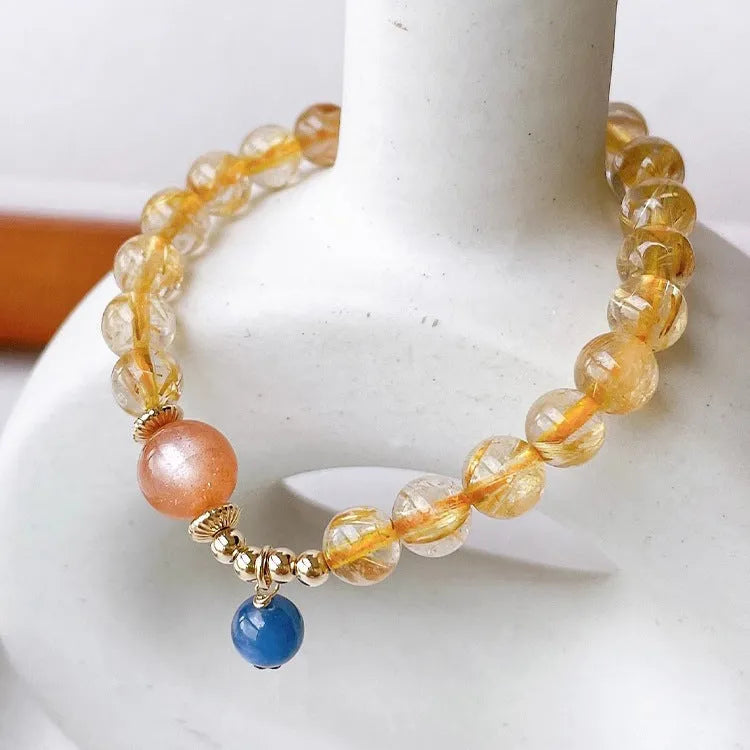 Women's gold rutilated quartz sunstone crystal bracelet with diamond beads
