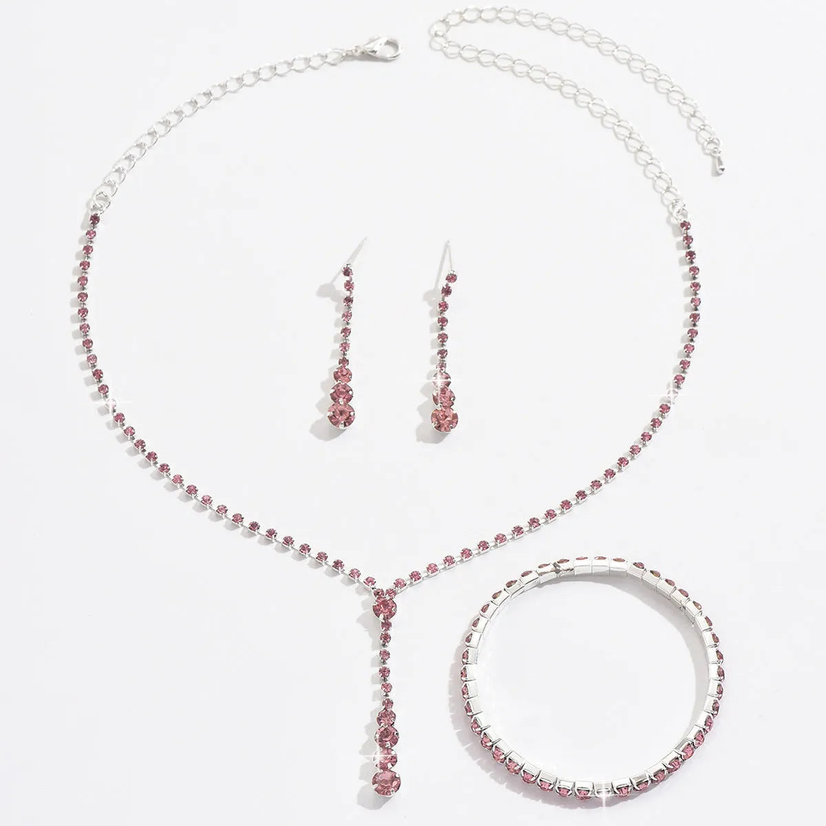 Wedding jewellery three-piece set showing necklace, bracelet and earrings with rhinestone pendants