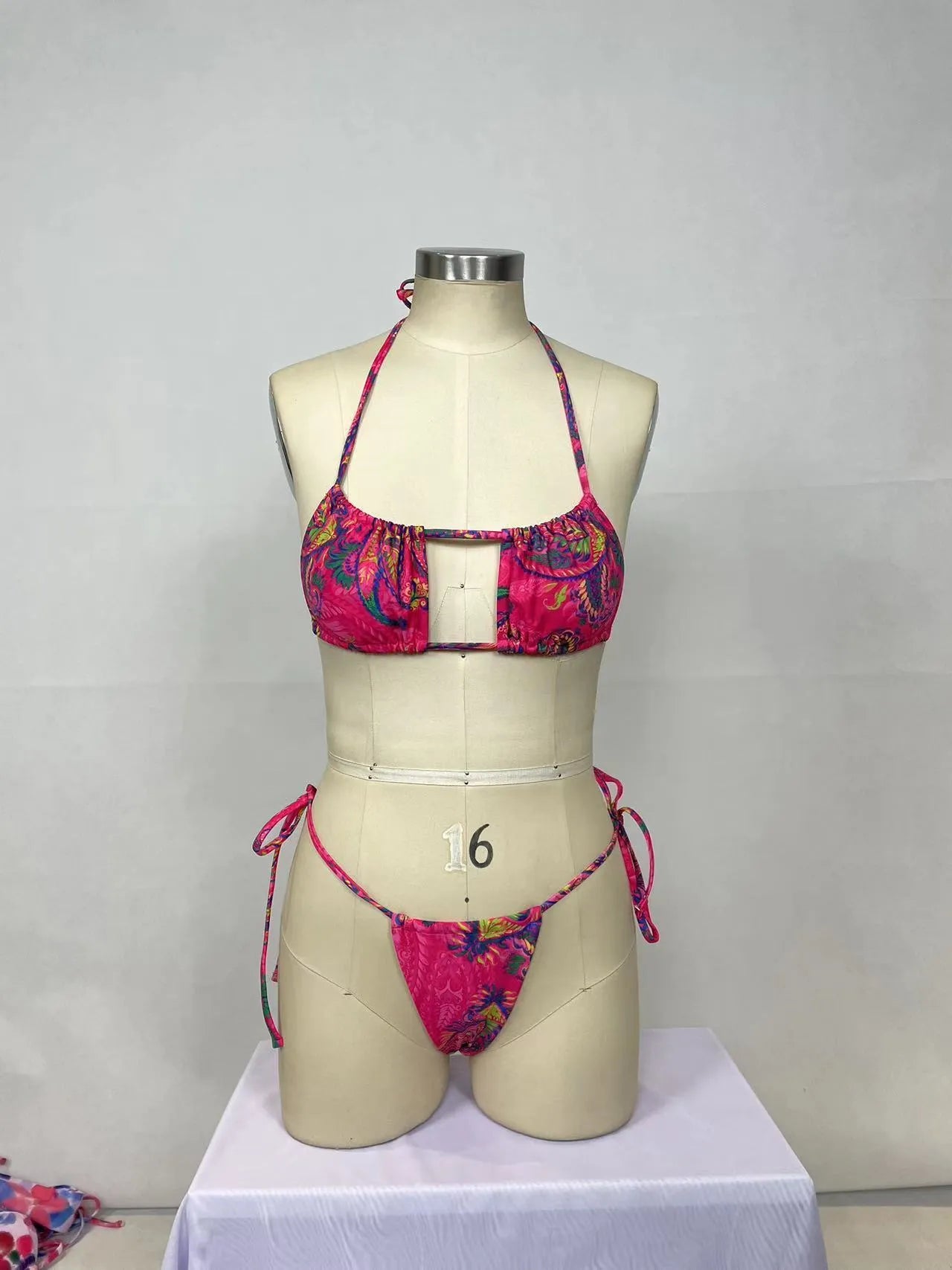 Pink printed women's two-piece bikini swimsuit with brief styling and backless design