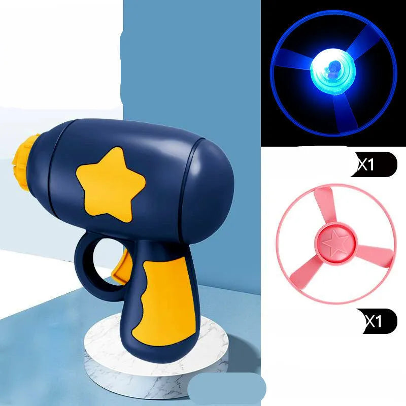 Blue flying saucer launcher gun and three LED flashing discs on a yellow background.