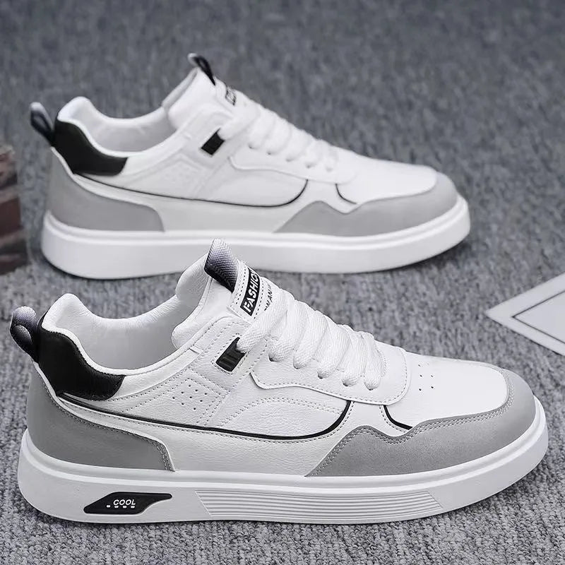 Men's low-top canvas board shoes in beige with leather stitching detail on a white background.