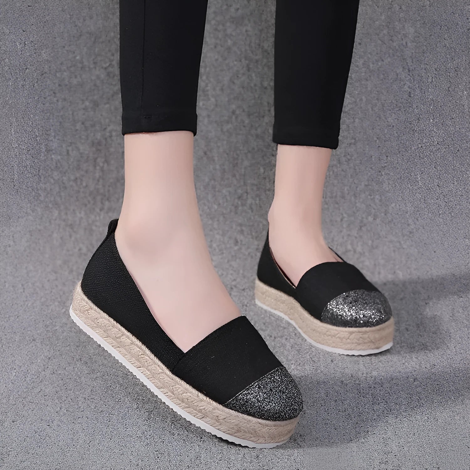 Women's plus size black canvas slip-on flat shoes with round toe, shown from the side.