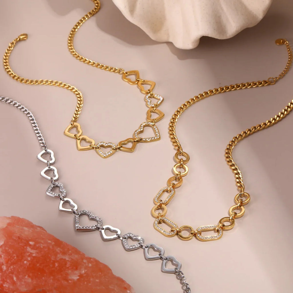 Geometric heart-shaped stainless steel pendant necklace with 18K gold finish on clavicle-length regular chain