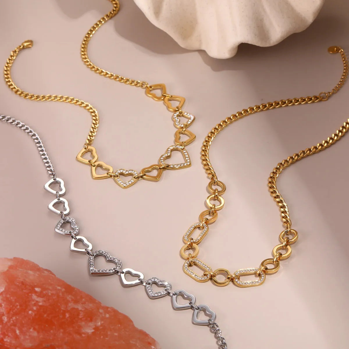 Geometric heart-shaped stainless steel pendant necklace with 18K gold finish on clavicle-length regular chain