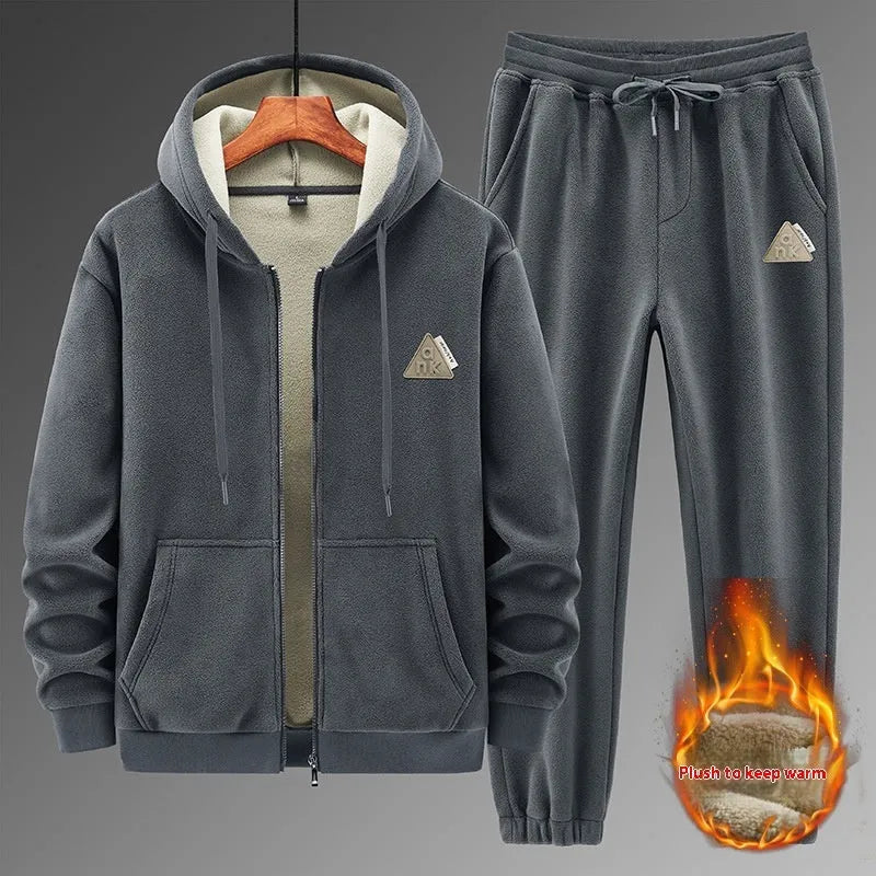Grey cashmere hooded sportswear suit with long sleeves and matching trousers on a hanger