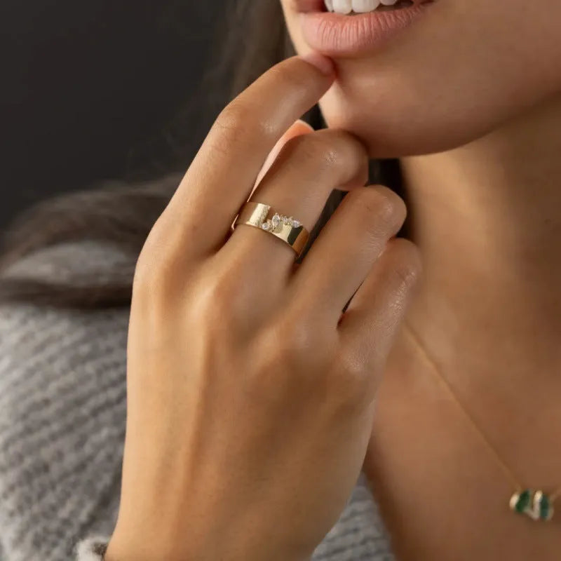Gold electroplated women's copper ring with shining zircon details showing personality style