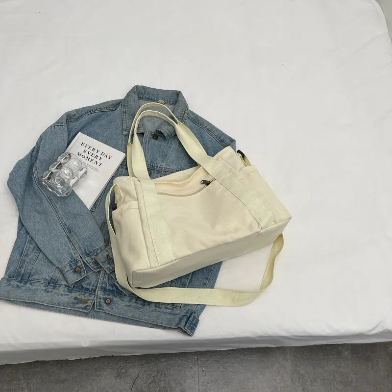 Large capacity polyester canvas shoulder tote bag in a solid colour, showing outer sandwich pocket.