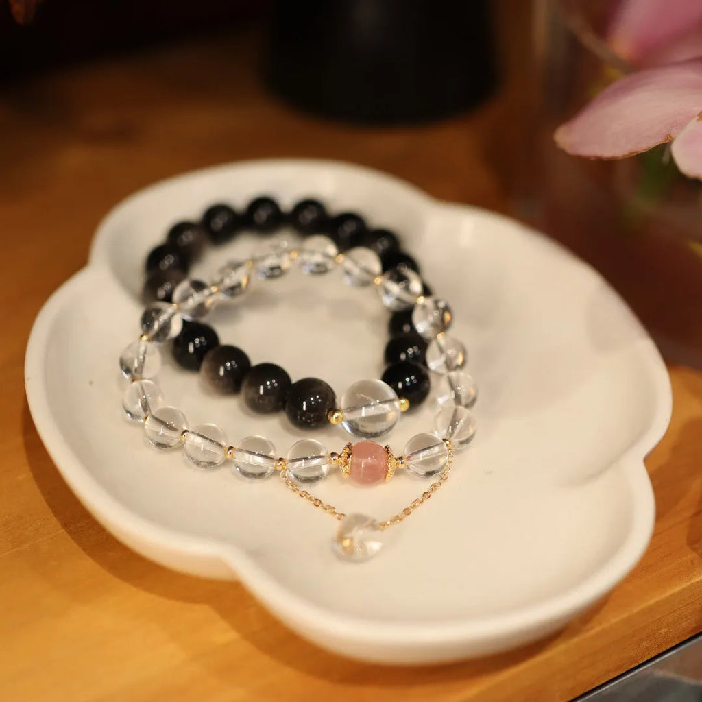 White crystal bracelet with geometric Chinese auspicious patterns and cat eye obsidian detailing