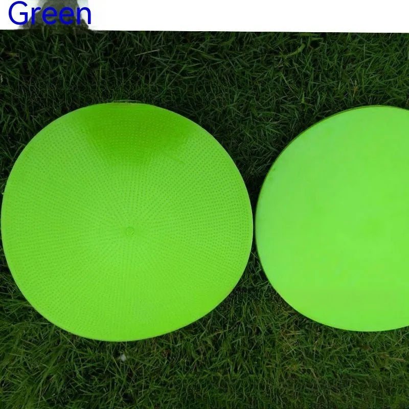 23cm diameter football training landmark pad in bright colours on grass field