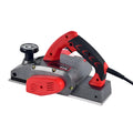 Red desktop electric wood planer with aluminium body, showing 82mm planing width and depth adjustment controls