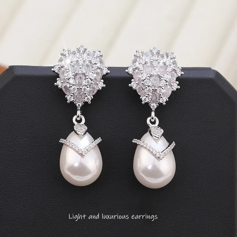 Women's drop-shaped earrings with pearl inlay and zircon stones on 18K copper