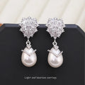Women's drop-shaped earrings with pearl inlay and zircon stones on 18K copper