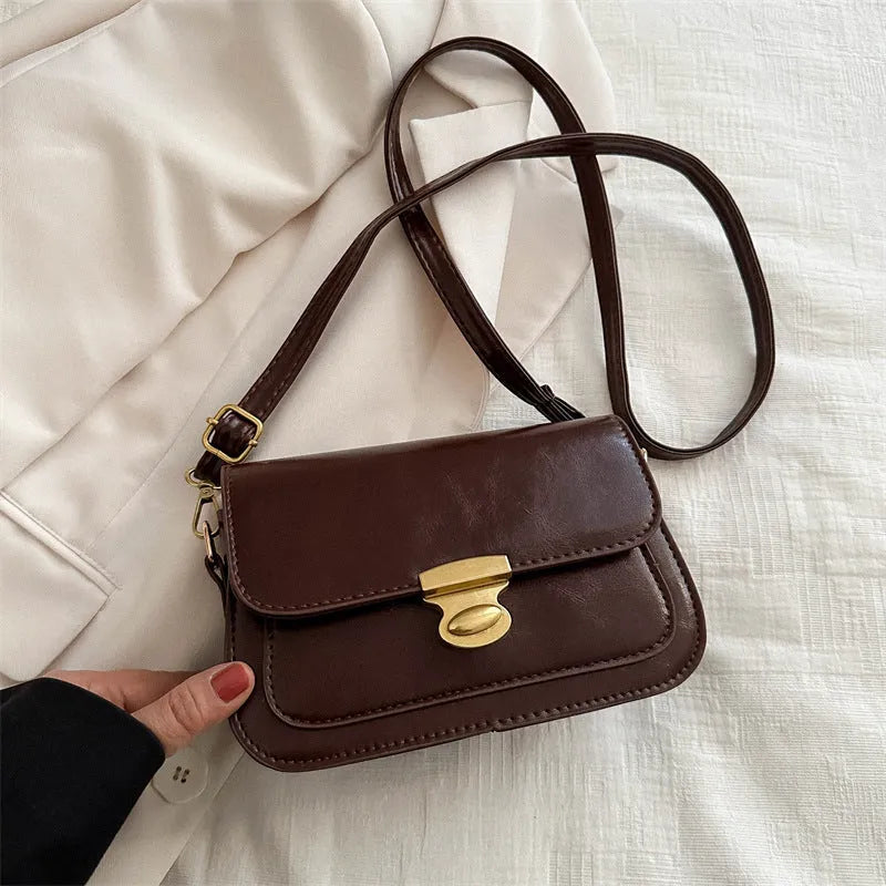 Small horizontal square handbag in soft PU leather, shown in black, brown, dark brown, and light brown.