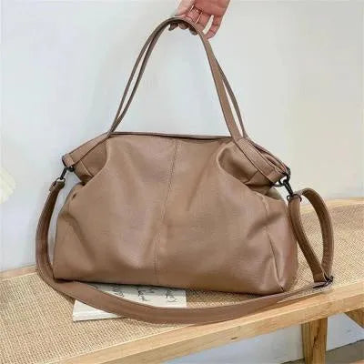Soft surface messenger shoulder bag in horizontal square shape with zipper opening and internal compartments