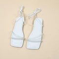 Women's flat sandals with ankle ring bandage cloth detail, square toe, and front lace-up straps in black.