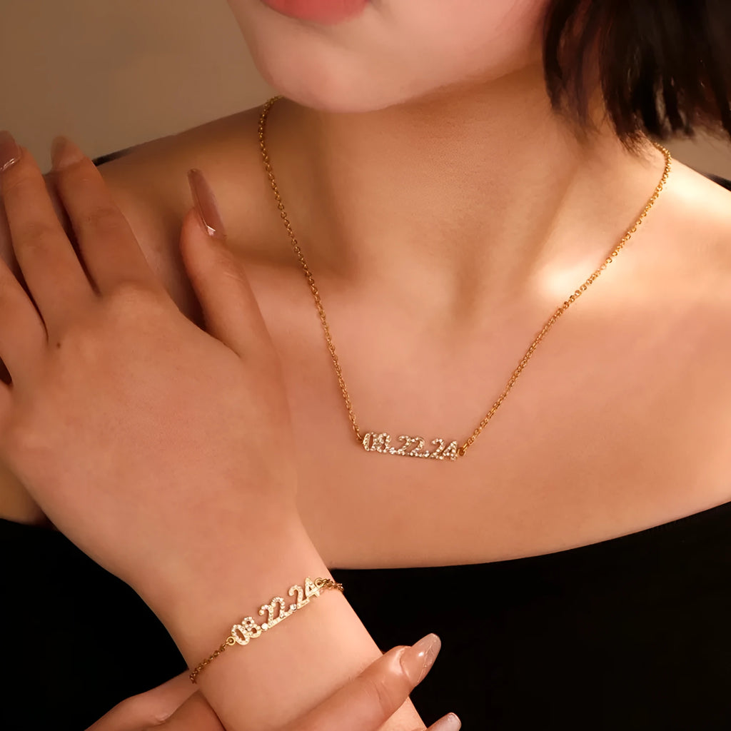 Stainless steel digital bracelet with diamond-studded numbers in gold finish on wrist.